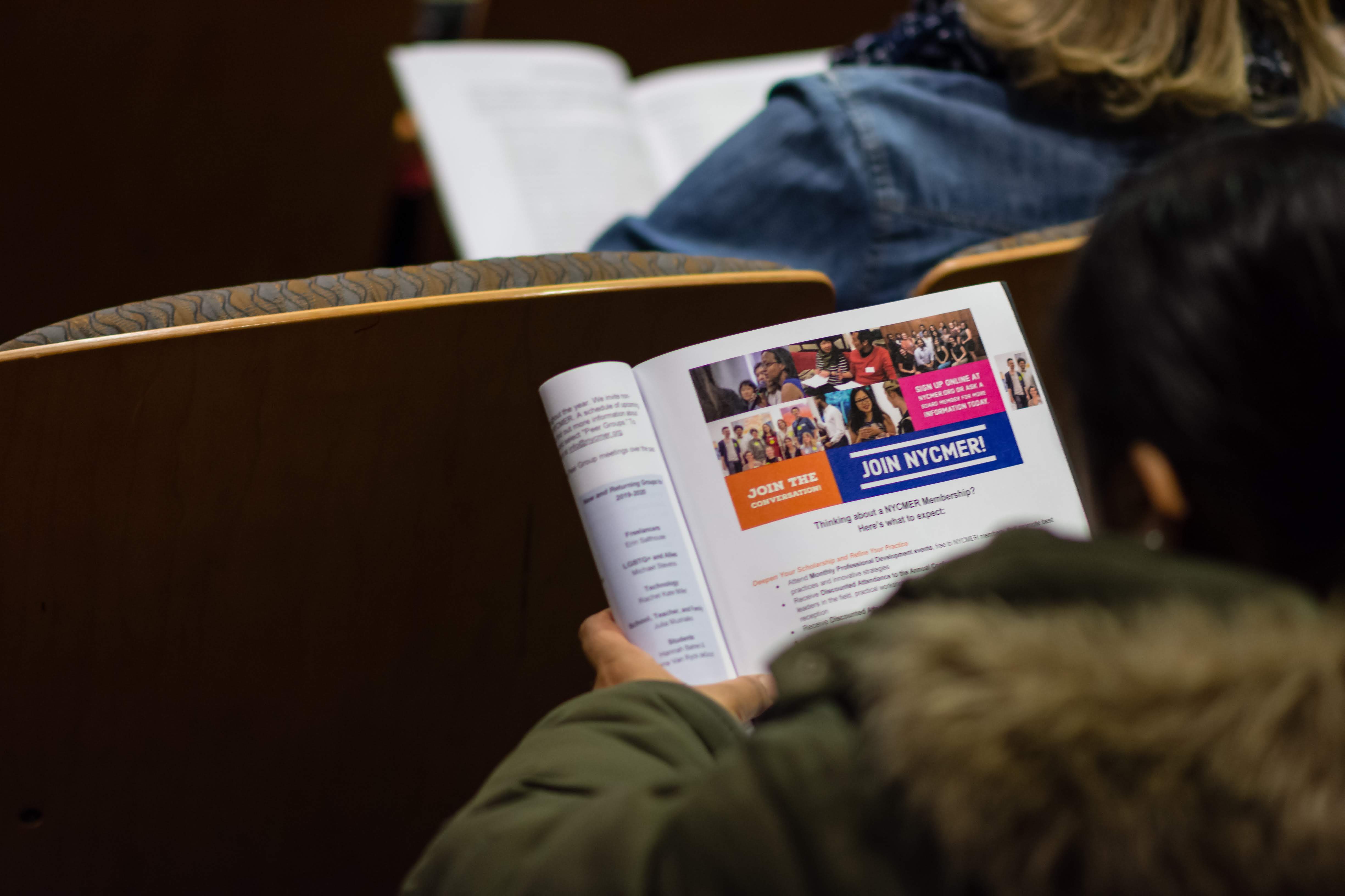 2019 NYCMER Conference-3 Photo looking over the shoulder of someone at their Conference program